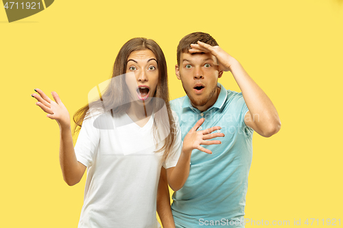 Image of Beautiful couple isolated on yellow studio background