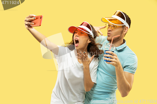 Image of Beautiful couple isolated on yellow studio background