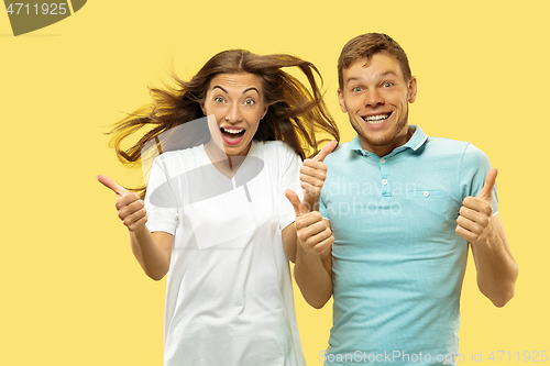 Image of Beautiful couple isolated on yellow studio background