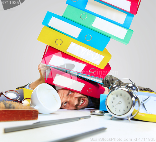 Image of Young man getting a lot of work and deadline