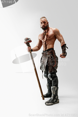 Image of Man in leather viking\'s costume isolated on white studio background