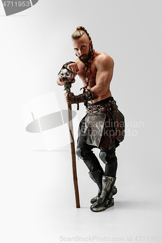 Image of Man in leather viking\'s costume isolated on white studio background