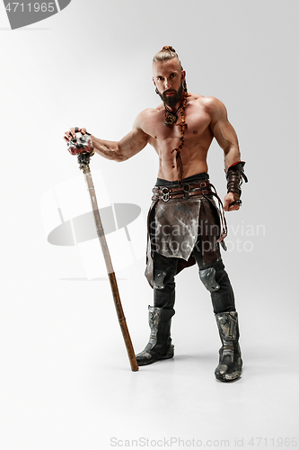 Image of Man in leather viking\'s costume isolated on white studio background