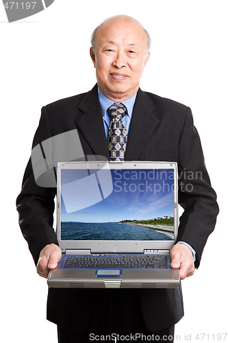 Image of Senior asian businessman and laptop