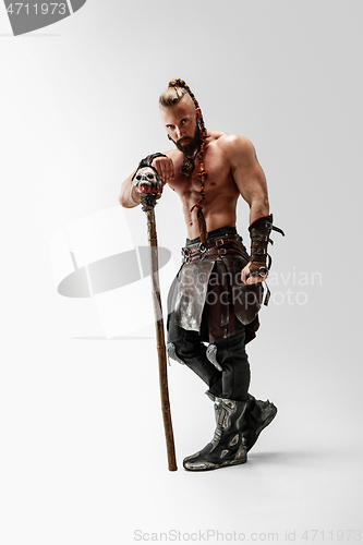 Image of Man in leather viking\'s costume isolated on white studio background