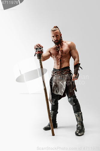 Image of Man in leather viking\'s costume isolated on white studio background