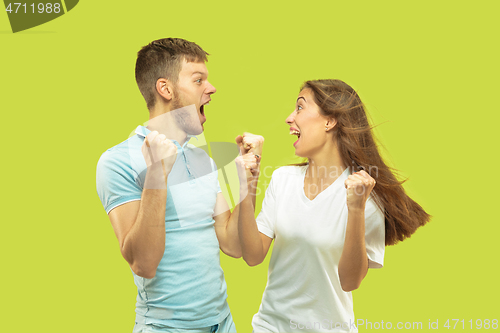 Image of Beautiful couple isolated on green studio background