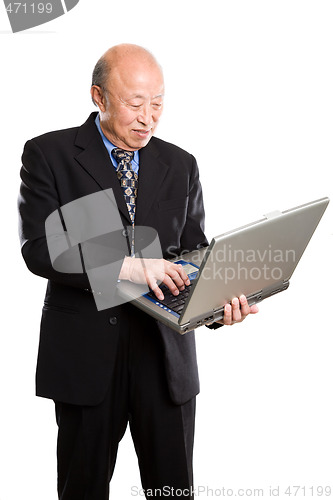 Image of Senior asian businessman and laptop