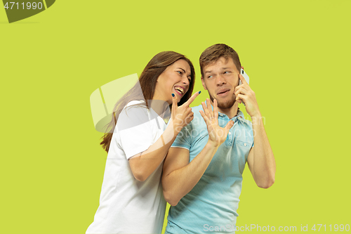 Image of Beautiful couple isolated on green studio background