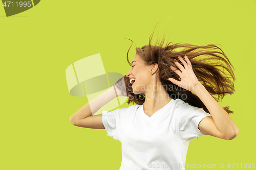 Image of Beautiful woman\'s portrait isolated on green studio background
