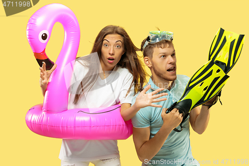 Image of Beautiful couple isolated on yellow studio background