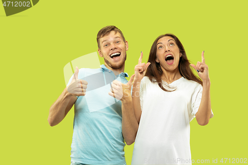 Image of Beautiful couple isolated on green studio background