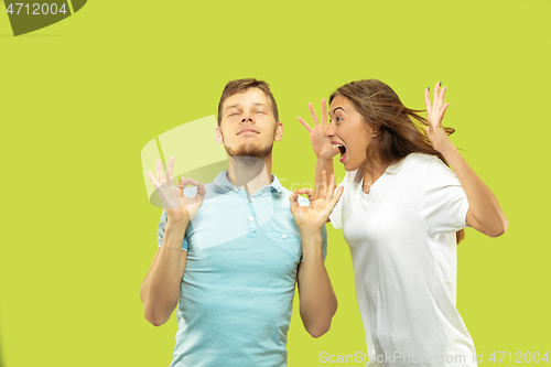 Image of Beautiful couple isolated on green studio background