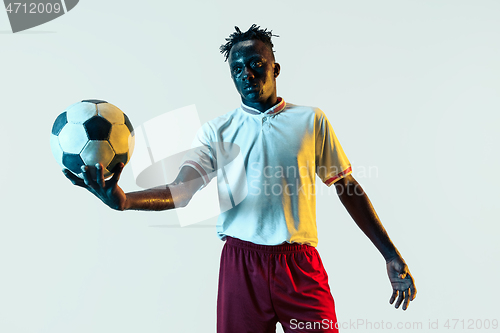 Image of Male soccer player standing with the ball isolated on white background