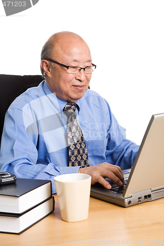Image of Working senior asian businessman