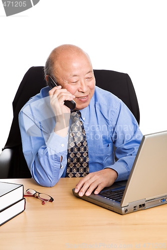 Image of Working senior asian businessman