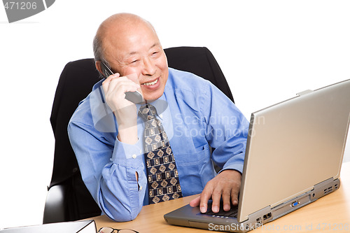 Image of Working senior asian businessman