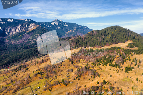 Image of Autumn pasture and rocky mountain behind