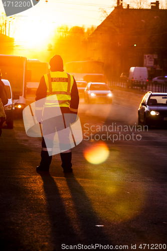 Image of Police officer observe busy traffic