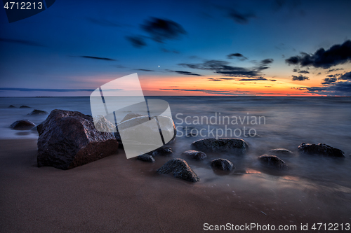 Image of Sea sunset seascape with wet rocks