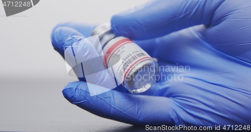 Image of Vaccine in human hands closeup footage