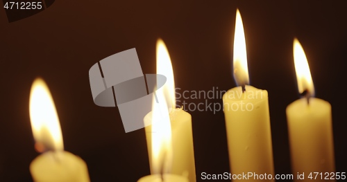 Image of Candles glowing against dark background