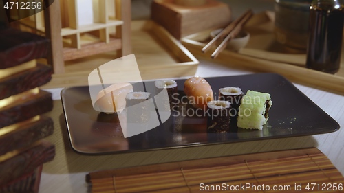Image of Filling plate with japanese sushi closeup