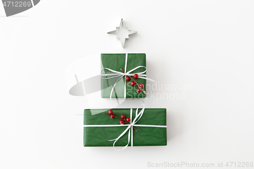 Image of green christmas gifts and mold in shape of star