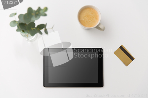 Image of tablet pc computer, credit card and cup of coffee