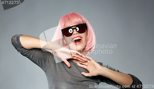 Image of happy woman in pink wig and black sunglasses