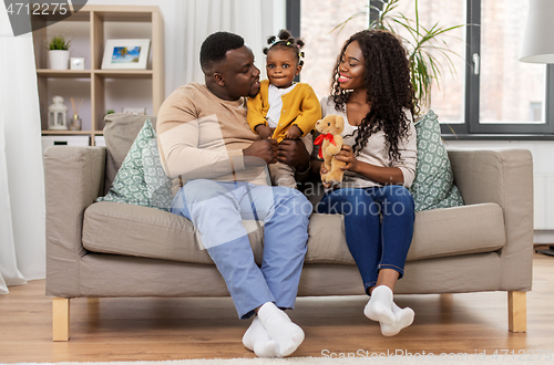 Image of happy african family with baby daughter at home