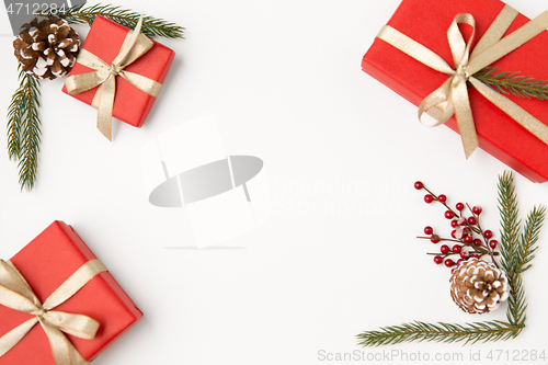 Image of christmas gifts and fir branches with pine cones