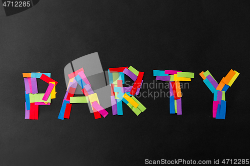 Image of party word made of multicolored papers on black