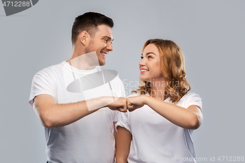 Image of portrait of happy couple in white t-shirts