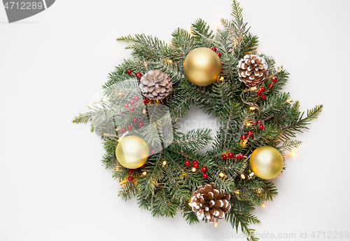 Image of christmas fir wreath with balls, cones and lights