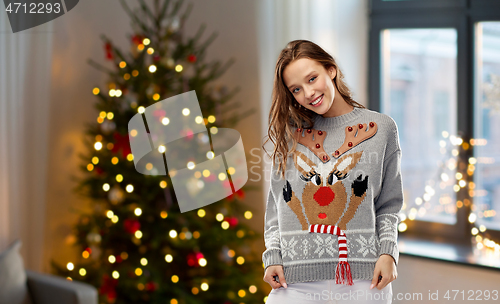 Image of woman in christmas sweater with reindeer pattern