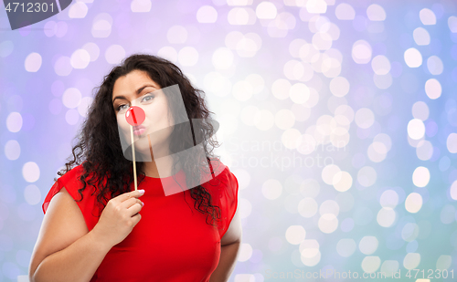 Image of happy woman with red clown nose posing