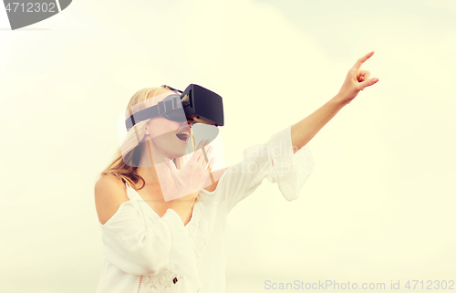 Image of woman in virtual reality headset pointing finger