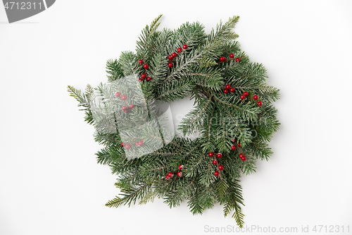 Image of christmas wreath of fir branches with red berries