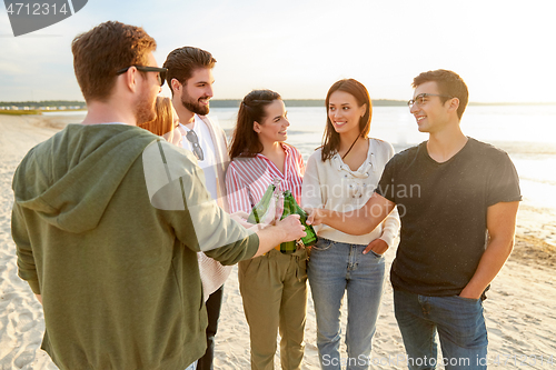 Image of friends toasting non alcoholic drinks on beach