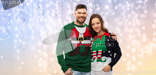 Image of happy couple at christmas ugly sweater party