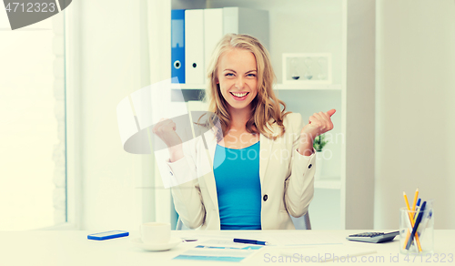 Image of happy businesswoman celebrating success at office