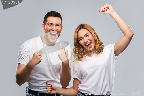 Image of portrait of happy couple in white t-shirts