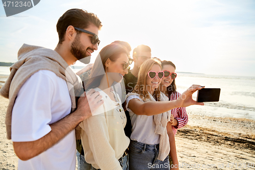 Image of happy friends taking selfie in summer