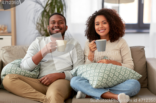 Image of african american couple drinking coffee at home