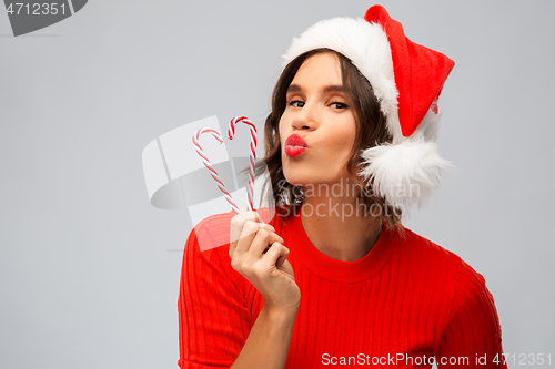 Image of happy young woman in santa hat on christmas