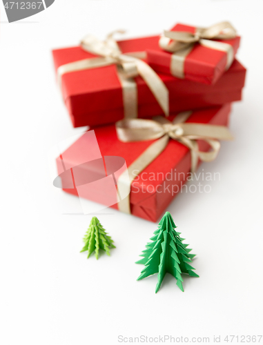 Image of gift boxes and christmas trees on white background