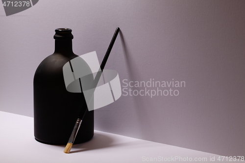 Image of Still life with luxury black glass of Rrum and paintbrush 
