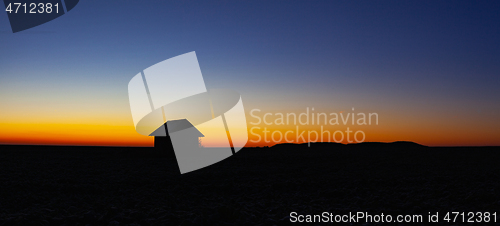 Image of Old barn on the field at sunrise