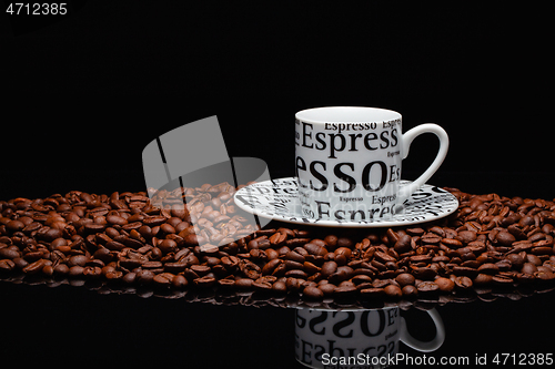 Image of Coffee mug on a pile of coffee beans 